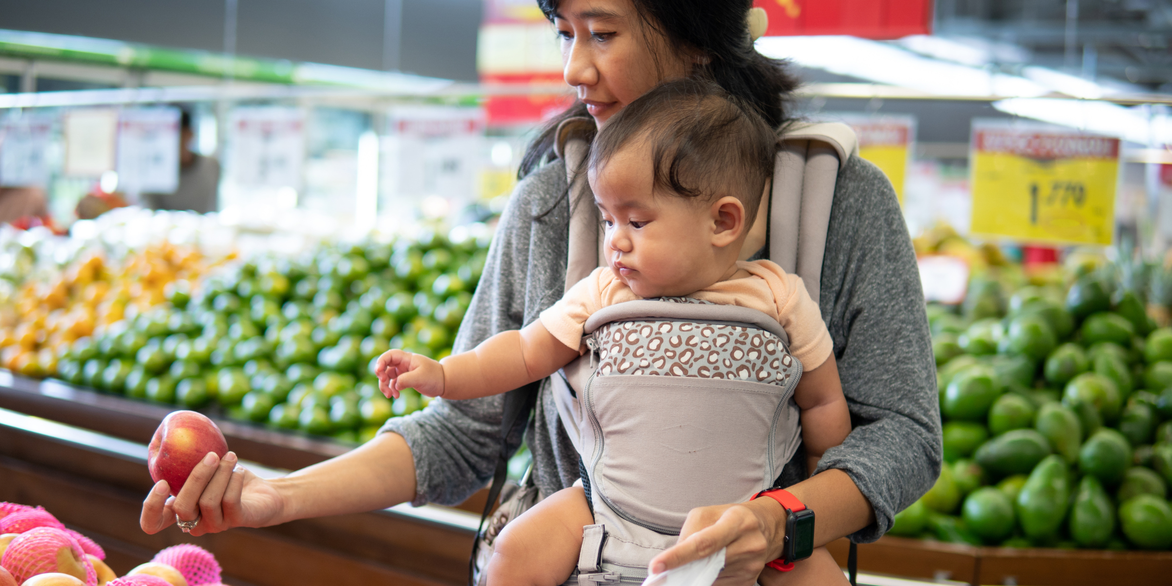 A mother and child shopping for groceries