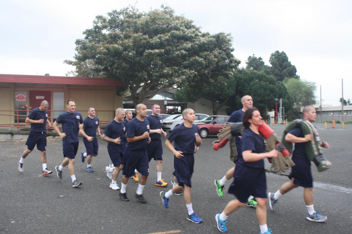 Hayward Fire Department recruits running drills carrying hoses