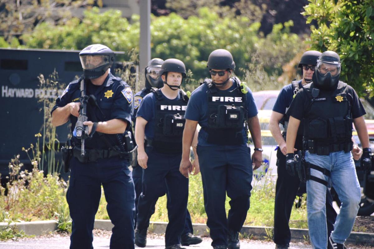 Police officers and fire fighters in tactical gear training