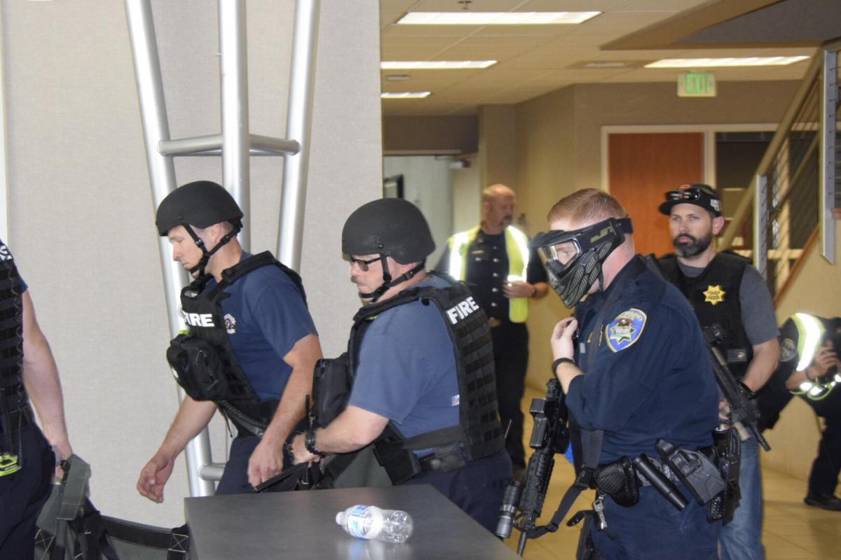 Police officers and fire fighter in tactical gear training