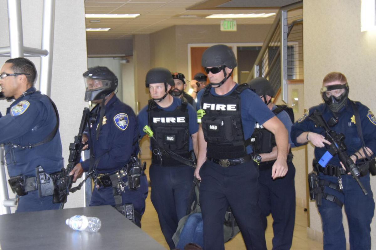 police officers and fire fighters in tactical gear training