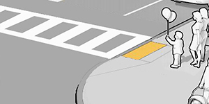 A woman and child waiting to cross at a crosswalk