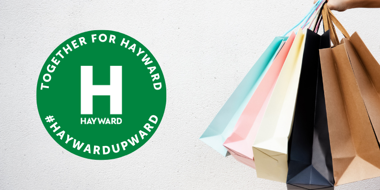 Shopping bags next to the Together for Hayward Gift Card logo
