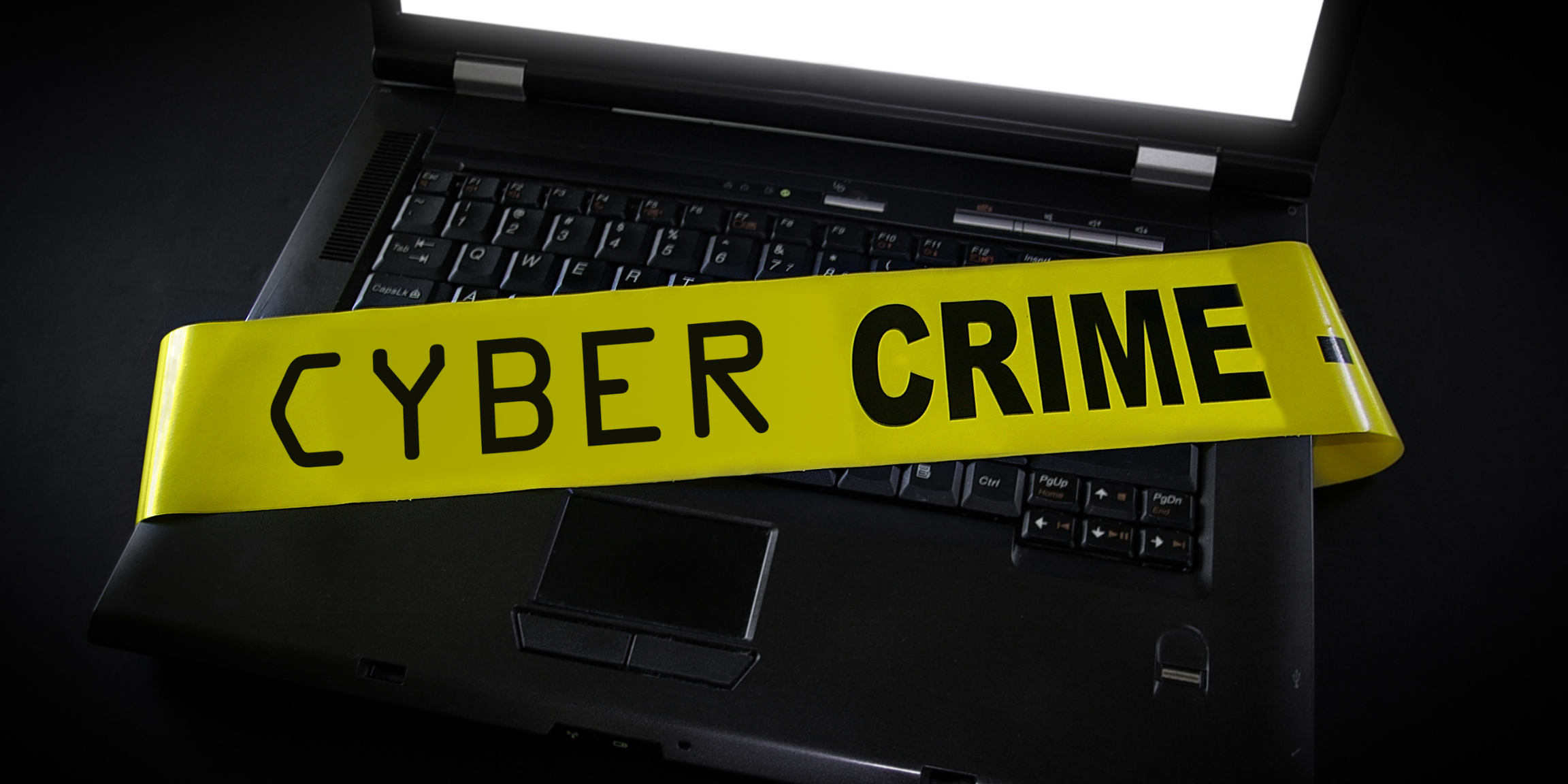 A laptop with "Cyber Crime" tape across it