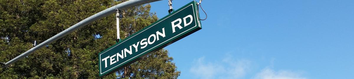 A green road sign that says Tennyson Rd.