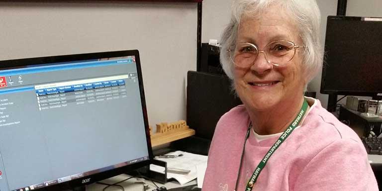 A VIPS volunteer working on a computer