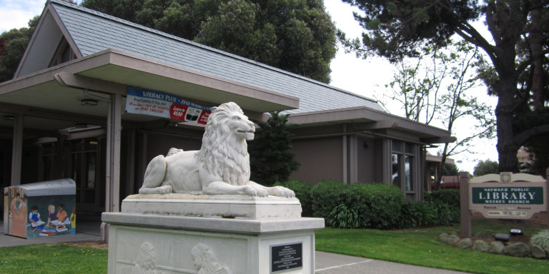 Exterior of Weekes Branch Library, the statue of the lion centered