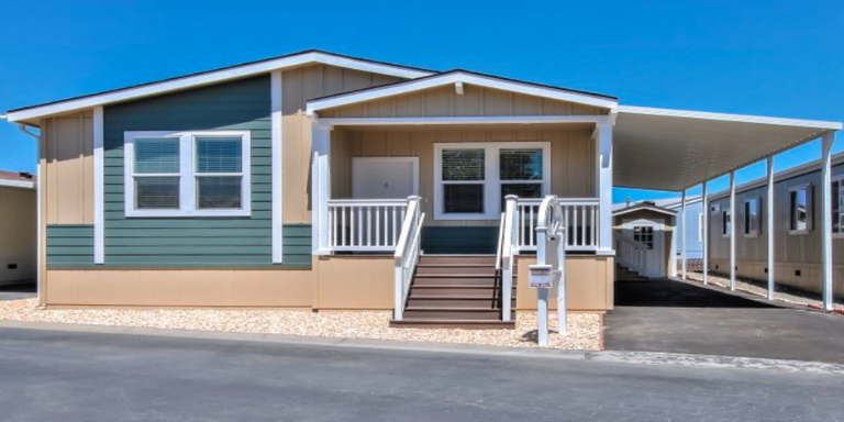 A green and tan mobile home