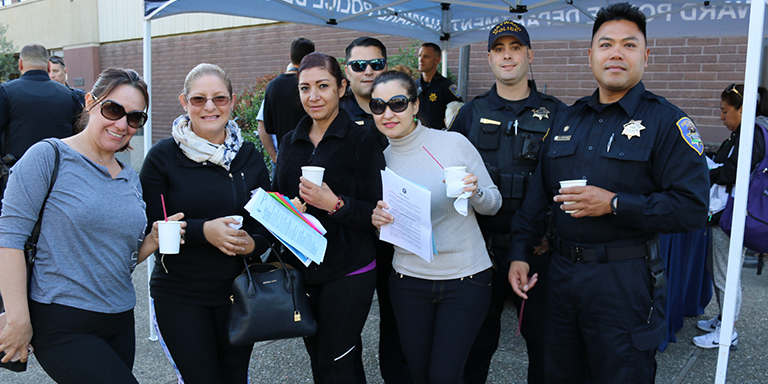 Residents having coffee with three officers outside of the Hayward Police Station