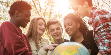 Teens holding a globe