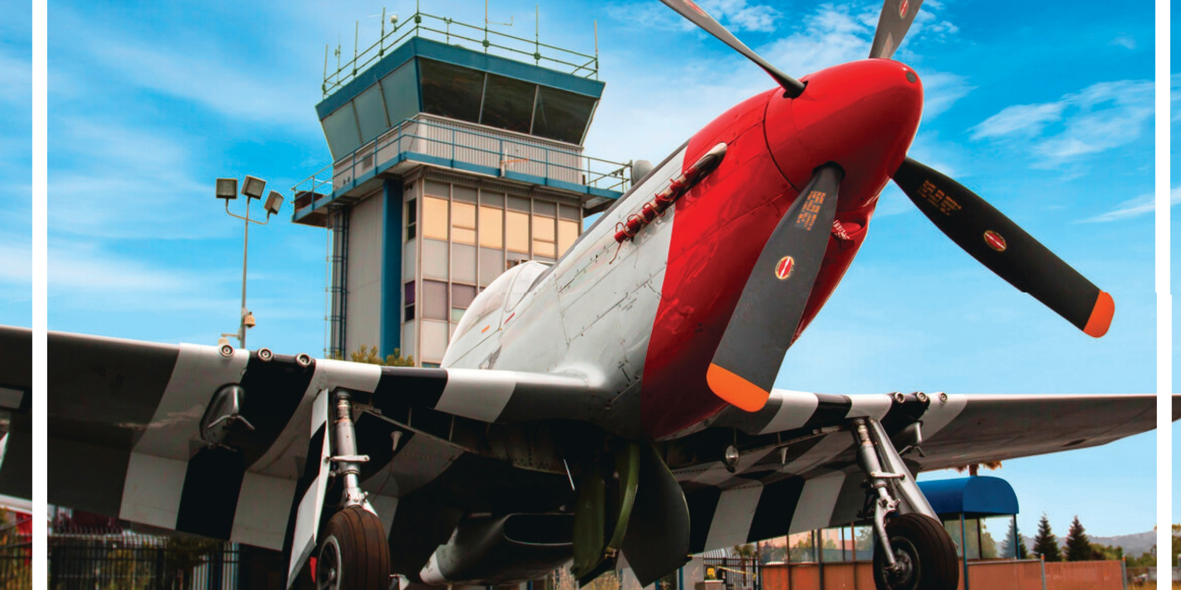 red, grey and black propeller plane in front of the Hayward Airport tower