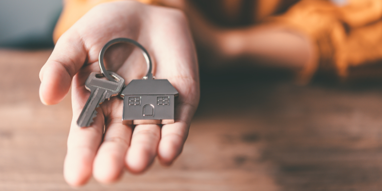 A hand holding house keys