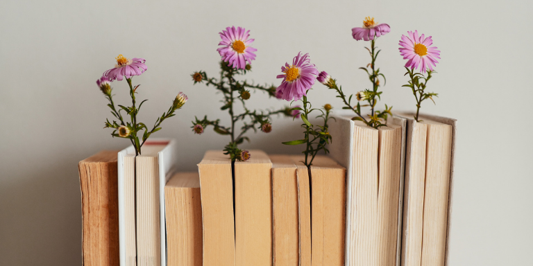 A row of books using flowers as bookmarks