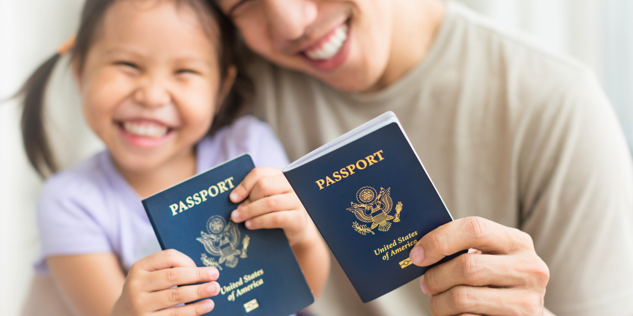 A man and a child holding up US passports