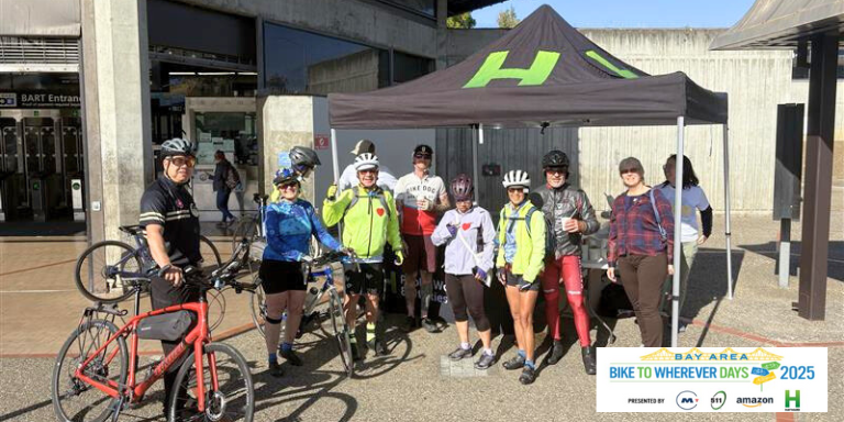 People in bike gear stopping at the Hayward charging station on Bike to Wherever Day