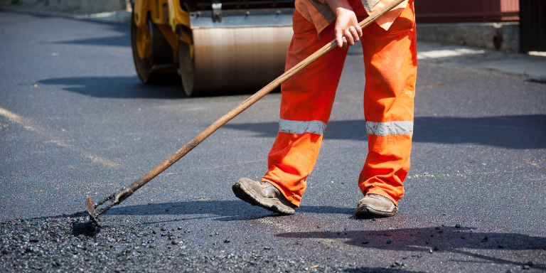 A person working on paving a street