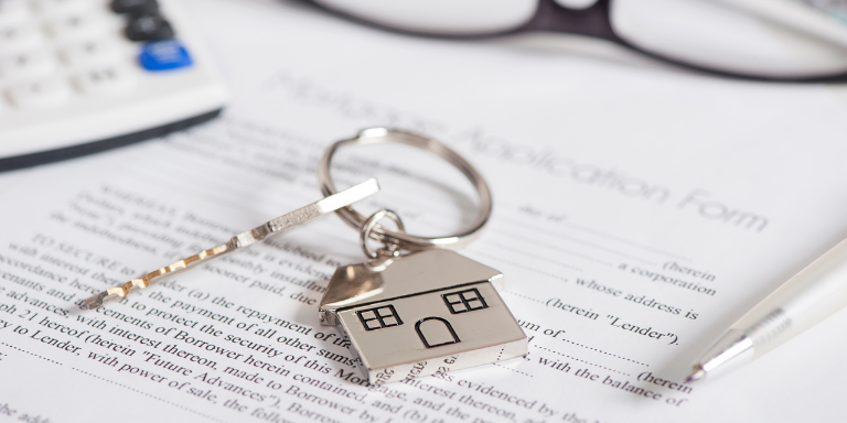 A key ring with a house on it