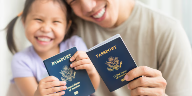 A family smiling with their passports