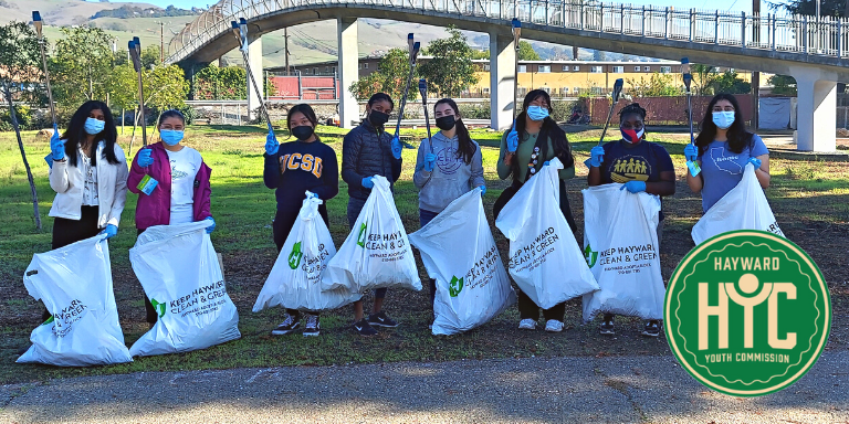 Photo of a group of Hayward Youth Commissioners during a litter clean-up event outdoors, wearing masks.