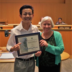 Young man in a white dress shirt standing next to Mayor Halliday