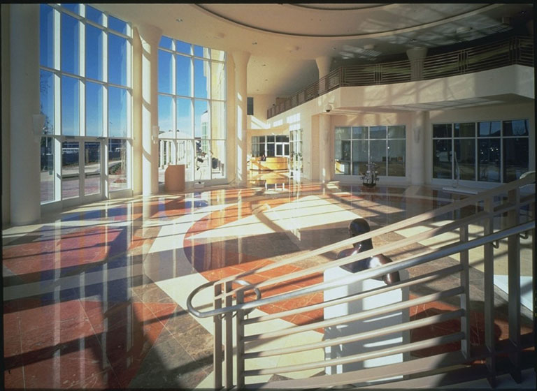 Round room with marble floors and floor to ceiling windows