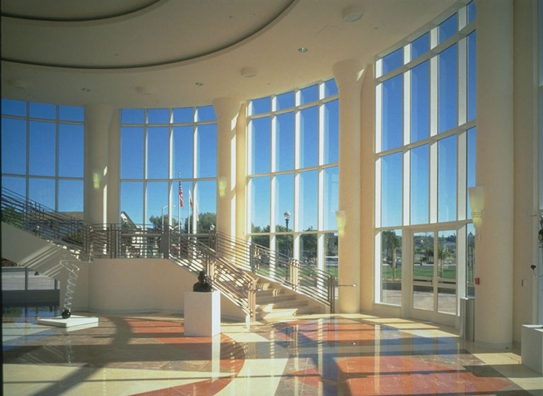 Large round room with floor to ceiling windows and marble floors