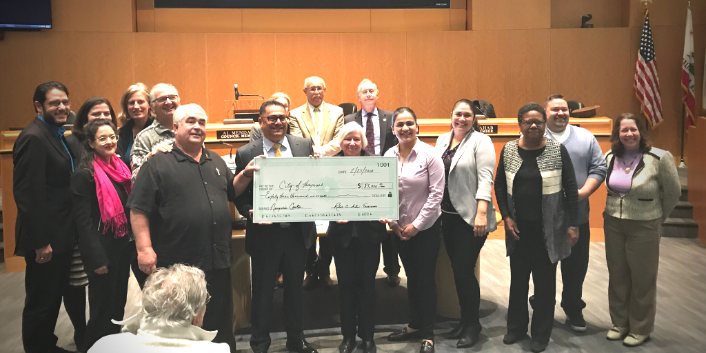 The rotary standing with the City Council presenting a large check