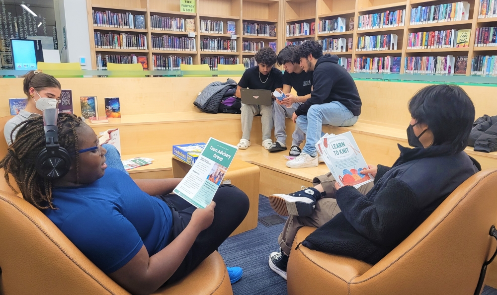 Seated teens collaborating on volunteer activities.