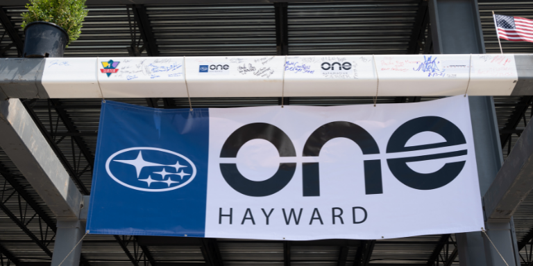A signed support beam and a sign that reads One Hayward at the new Hayward Subaru location