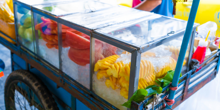 fruit on ice in a vendor cart