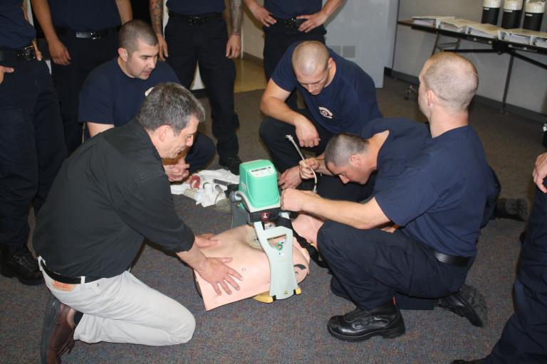 Fire fighter recruits practicing how to intubate patients in a classroom