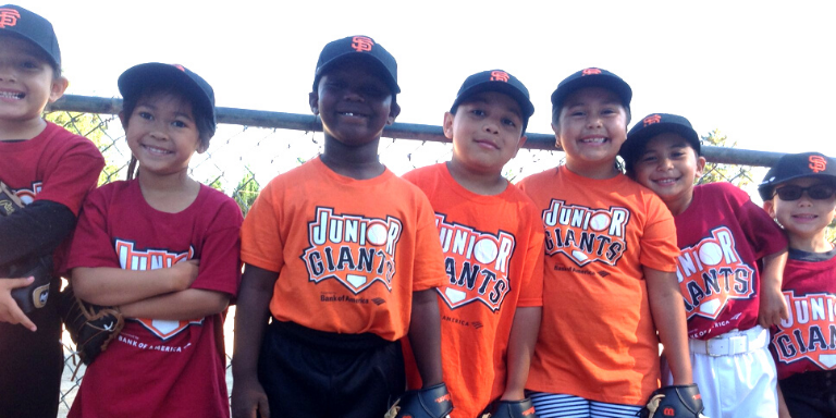 Children wearing Junior Giants Tee Shirts smiling