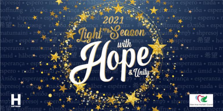 Blue banner with gold stars circling the words Light up the Season with Unity and Hope