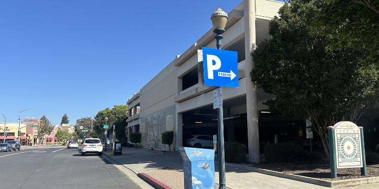 Blue sign with a white letter "P" indicating parking nearby